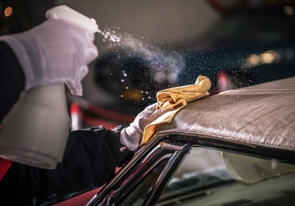 Men Spraying Vinyl Protectant For the Convertible Car Soft Roof.