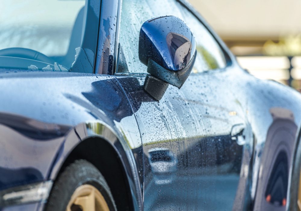 Car Wash Theme. Automotive Industry. Clean, Blue and Modern Luxury Car Right After Washing. Side View.