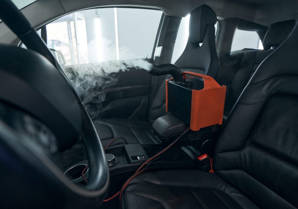 Sanitizing clean of car interior. Steering wheel, dashboard and seats disinfection and sterilization